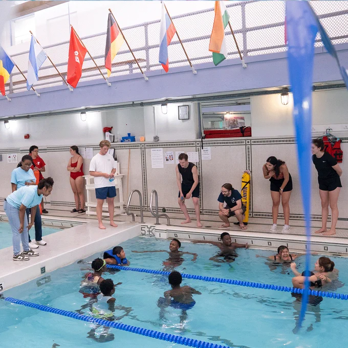 Medical students instructing children and teens on water safety