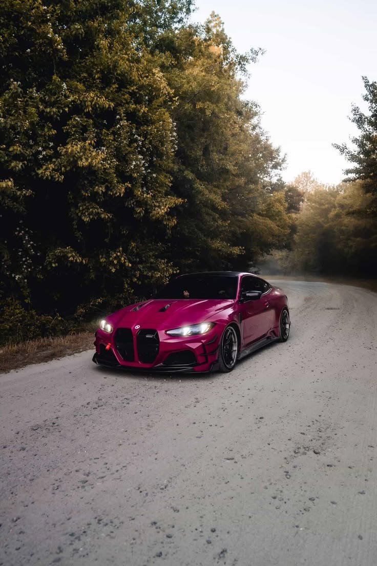 bekscott2's tweet photo. Cutting through a forgotten backroad wrapped in green. This magenta paint pops hard against the trees. 🌸🚗 https://t.co/JohQhzXjCy