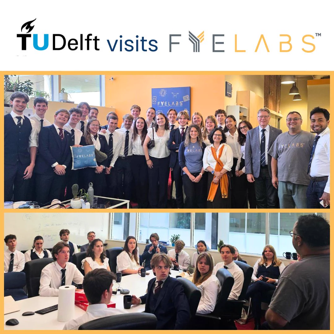 The image announces a visit from Delft University of Technology (TU Delft) of Netherlands to FYELABS headquarters. At the top, the TU Delft and FYELABS logos appear alongside the title, "TU Delft visits FYELABS." Below are two photographs from the visit. The first shows approximately 21 graduate and undergraduate engineering students, assistant professors, and the FYELABS team gathered together for a group photo inside the FYELABS headquarters at McMaster Innovation Park. The second shows the students seated around a boardroom table, listening attentively during a presentation and discussion about product development, engineering innovation, and technology with the FYELABS team.