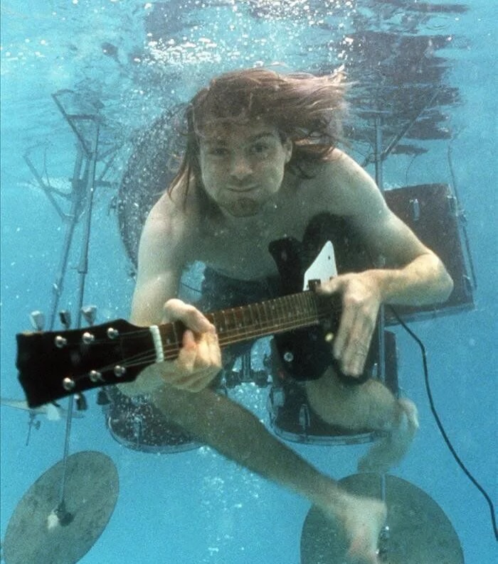 historyinmemes's tweet photo. When Nevermind was released in 1991, Kurt Cobain was far from living the life of a rock star. He had been evicted from his apartment and was reportedly living out of his car as Nirvana’s breakthrough album began changing music history.

In the summer of 1991, shortly after returning from Los Angeles where Nirvana had recorded Nevermind, Kurt Cobain was evicted from his apartment in Olympia. He came home to find his belongings—including clothes, lyrics, and musical equipment—packed into boxes and left on the sidewalk because he could no longer afford the rent.

For the following weeks, Cobain lived out of his 1963 Plymouth Valiant and stayed on friends’ couches, struggling financially just as he was on the verge of releasing a major-label album that would change music forever.

When Nevermind arrived in September 1991 and became a worldwide sensation, Cobain’s circumstances changed dramatically. However, the eviction remains one of the most well-known reminders of the difficult period he endured before finding fame.