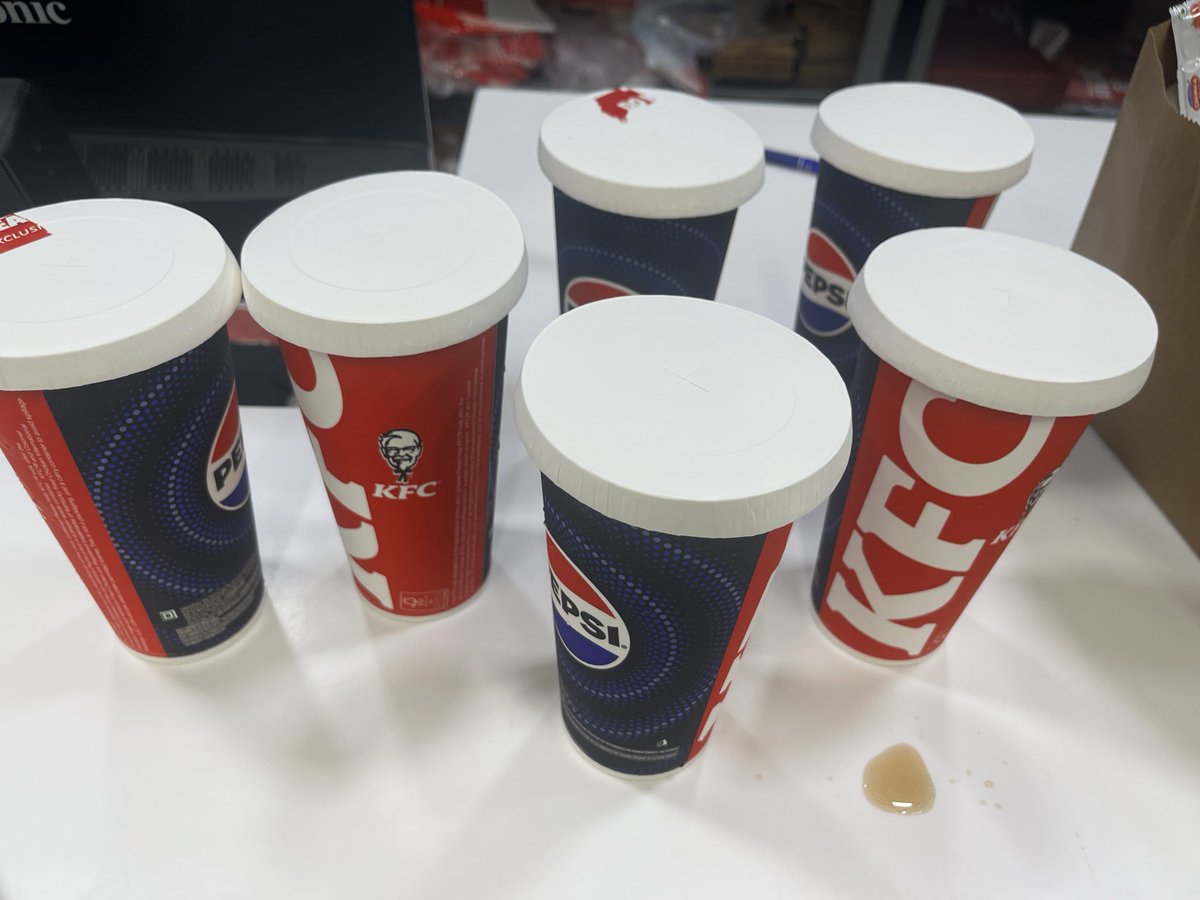 NathanRebello2's tweet photo. takeaway at @KFC_India . Food came in flimsy paper glasses &amp; lids. Staff is demanding ₹11 extra per plastic container (I need 6)! The app had NO option for containers, only a 'carry bag' which I already selected. How am I actually supposed to carry this? 🤷🏽‍♀️🍗 #KFCIndia #KFC https://t.co/LBOdb2VZDK