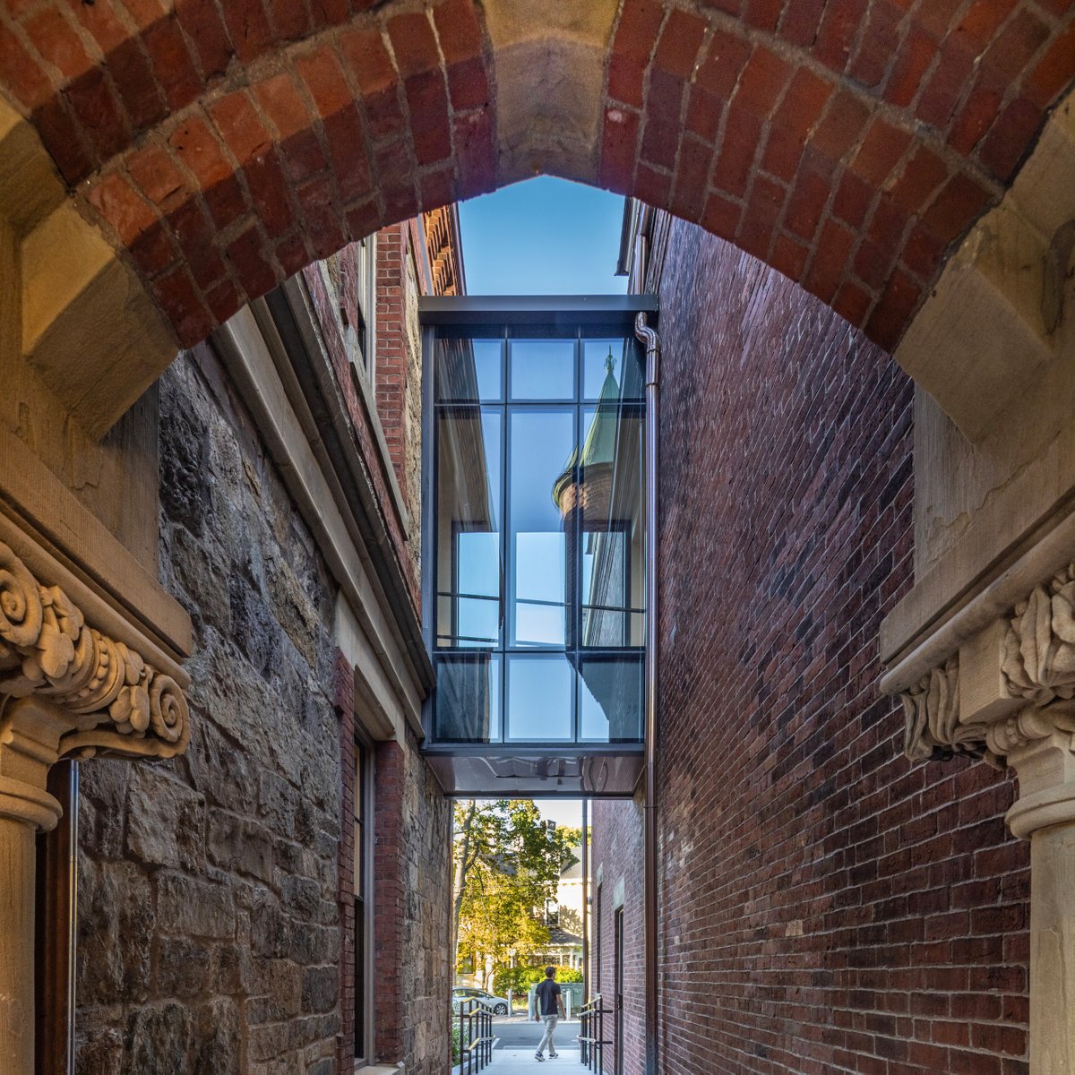 Centerbrook's tweet photo. Carefully integrated interventions at @lesley_u remove barriers while respecting the historic fabric. A new bridge, elevator, accessible arcade, and sloped walkways create seamless connections between buildings, ensuring all users share a common and intuitive experience. https://t.co/EeHreqZkg0
