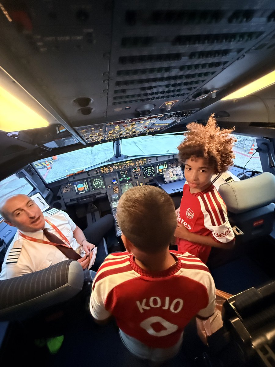 kofigabs's tweet photo. My older son asked if he could take a picture with the pilot, and the pilot happily invited him into the cockpit. He entered with his brother, both wearing Arsenal shirts, while I followed proudly in my Manchester United shirt.

The pilot looked at them and asked, “Why are you two wearing Arsenal shirts when your father supports United?” Then he turned to me and said, “Manchester United—we are the best!” I agreed, and we sealed it with a fist bump! 😂👊🏾🔴

It was a beautiful experience for my boys. We didn’t just take a flight; we created memories they will carry for life. Happiness is found in moments like these .✈️❤️