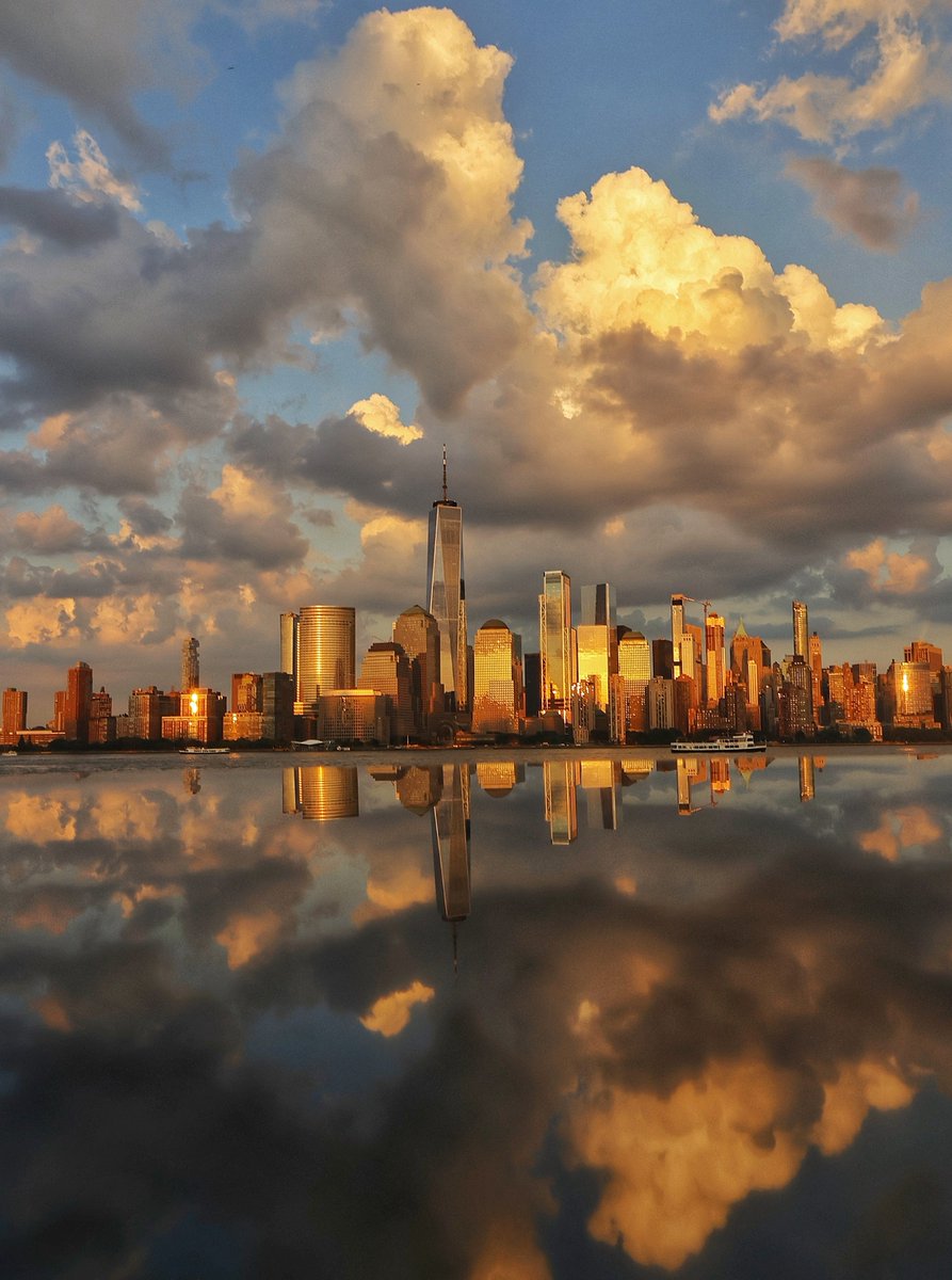 GaryHershorn's tweet photo. A golden hue across the skyline of lower Manhattan and One World Trade Center as the sun sets in New York City, Thursday evening #newyorkcity #nyc #newyork #sunset https://t.co/JLxdSPTEyU