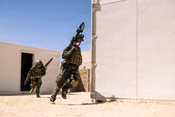 U.S. Marines with Fox Company, 2nd Battalion, 1st Marine Regiment, 1st Marine Division, move to a building during a platoon attack as a part of Adversary Force Exercise 4-26 at Marine Corps Air-Ground Combat Center Twentynine Palms, California, July 28, 2026. AFX serves as an opportunity for units to receive training and certification across multiple warfighting functions in realistic force-on-force scenarios. (U.S. Marine Corps photo by Sgt. Vincent Needham)\n\n