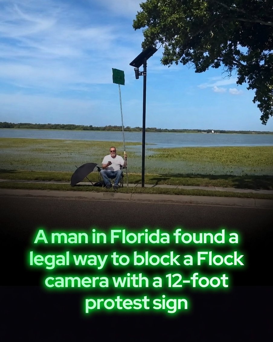 Rainmaker1973's tweet photo. A 77-year-old Florida man is blocking Flock cameras with a 12-foot protest sign.

Carl Gunn has staged at least two protests in St. Petersburg using a pool-cleaning pole with a sign attached to its end. He sits beside the camera in a folding chair and positions the sign directly in front of its lens.

The sign reads, “DOWN WITH FLOCK CAMERAS.”

Unlike protesters who have damaged or removed the cameras, Gunn’s unusual approach does not physically touch the equipment. During one protest, two police vehicles arrived at the scene, although public court records reportedly show no case filed under his name.

Flock cameras are automatic license plate readers that photograph passing vehicles and record details including their license plates, locations, and travel times. Police can search that information while investigating crimes or trying to locate vehicles.

The company says its technology helps departments solve crimes more quickly. Critics argue that recording vehicles indiscriminately creates a vast surveillance network capable of tracking people who are not suspected of any crime.

“We didn’t give them permission to do it on us,” Gunn told Creative Loafing Tampa Bay. “If they want to do it for profit, I want my paycheck.”

Flock’s network reportedly includes nearly 100,000 cameras across the United States. Its rapid expansion has provoked growing resistance, including public campaigns, proposed restrictions, and acts of vandalism.

Gunn’s protest appears designed to make the camera ineffective without damaging it. Whether officials consider blocking its view permissible may depend on local laws and exactly where a protest takes place.

For now, his combination of a pool pole, homemade sign, and lawn chair is drawing national attention to a much larger debate over privacy and police surveillance.

[📷 harborhoney]