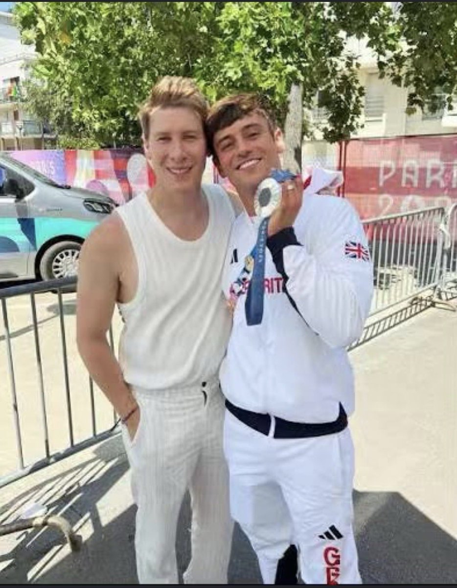 SceneOrbit's tweet photo. Tom Daley with his silver medal and husband Dustin Lance Black at the Paris 2024 Olympics. 🥈❤️ https://t.co/bJU8QVSlBS