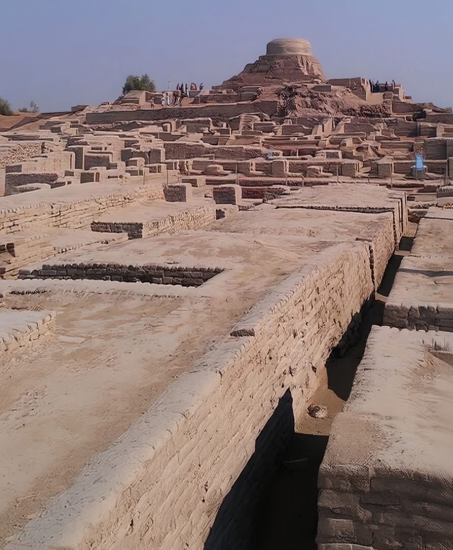 UnearthedHQ's tweet photo. The 4,600-Year-Old Lost City That Was More Advanced Than Many Medieval Towns

Deep in the plains of present-day Pakistan lies one of humanity’s greatest forgotten wonders — Mohenjo-daro, the mysterious city of the ancient Indus Valley Civilization. Built around 2600 BC, at a time when much of the world was still struggling with basic settlement life, this astonishing city already had organized streets, advanced engineering, and one of the world’s earliest urban sanitation systems.

The name Mohenjo-daro means “Mound of the Dead,” and for thousands of years the city remained buried beneath dust and silence. It was rediscovered in the 1920s by archaeologists during British India, shocking historians across the world. What they uncovered changed our understanding of ancient civilization forever.

Unlike many ancient cities ruled by giant palaces or massive temples, Mohenjo-daro was designed with incredible planning and precision. Streets were laid out in a grid pattern, homes were built using standardized baked bricks, and nearly every house had access to water and drainage. Even more surprising, the city had covered sewage systems running beneath the streets — something many civilizations would not achieve again for thousands of years.

One of its greatest mysteries is the famous “Great Bath,” believed to be one of the earliest public water structures ever built. The massive brick-lined pool was waterproofed with natural bitumen and connected to an advanced drainage system. Historians believe it may have been used for rituals, purification, or important community gatherings. Imagine people walking through these streets over 4,500 years ago, using technology and city planning far ahead of their time.

No one knows exactly who ruled the city. No giant king’s tomb has ever been found. No massive statues celebrating rulers. Even stranger, the script of the Harappan people still cannot be fully decoded. Their language remains one of history’s greatest unsolved puzzles. It is as if an entire advanced civilization spoke… and then vanished without leaving a readable voice behind.

At its peak, the Indus Valley Civilization stretched across parts of modern-day India and Pakistan and may have supported millions of people. Trade routes connected it with ancient Mesopotamia, showing that these people were not isolated — they were part of a thriving ancient world economy.

Then, around 1900 BC, the civilization slowly declined. Some experts believe climate change, shifting rivers, droughts, or economic collapse may have forced people to abandon the cities. Others think repeated flooding damaged Mohenjo-daro over time. But the true reason remains uncertain.

Today, the silent ruins of Mohenjo-daro still stand under the burning sun of Sindh, reminding us that thousands of years before modern technology, humans were already building cities with intelligence, engineering, and organization far beyond what many imagined possible.