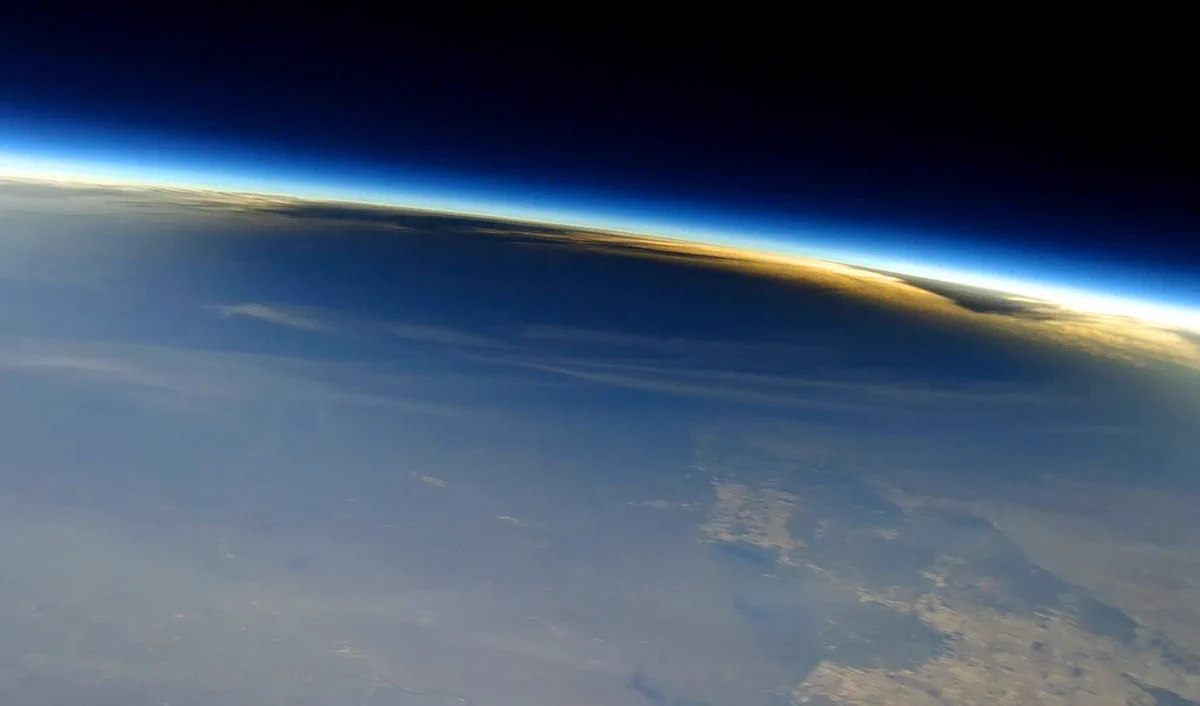 This image shows the Moon’s shadow on Earth during the total solar eclipse on April 8, 2024, as seen from about 90,000 feet from a camera carried by a scientific balloon. Earth's atmosphere is also visible in this image, with its distinctive glow. Credit: Nationwide Eclipse Ballooning Project/Virginia Tech