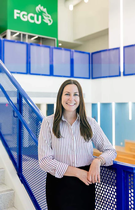 a professional headshot of a student standing on a staircase in cohen student union
