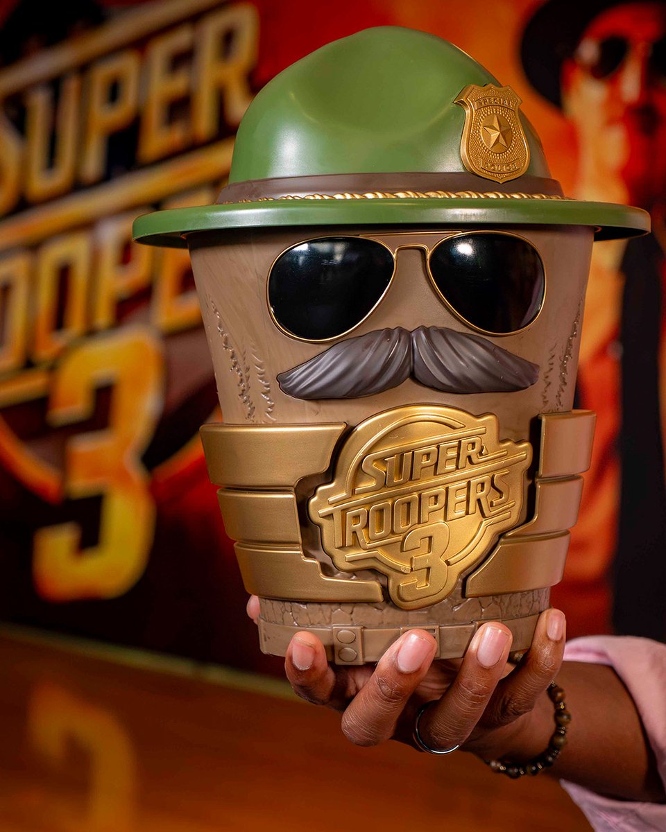 AMCTheatres's tweet photo. The popcorn tastes like popcorn. Pull over for our SUPER TROOPERS 3 popcorn collectible and get your 🎟️ to see the film, meow playing! https://t.co/UwLeho6R40 https://t.co/6HCKOGYAEF