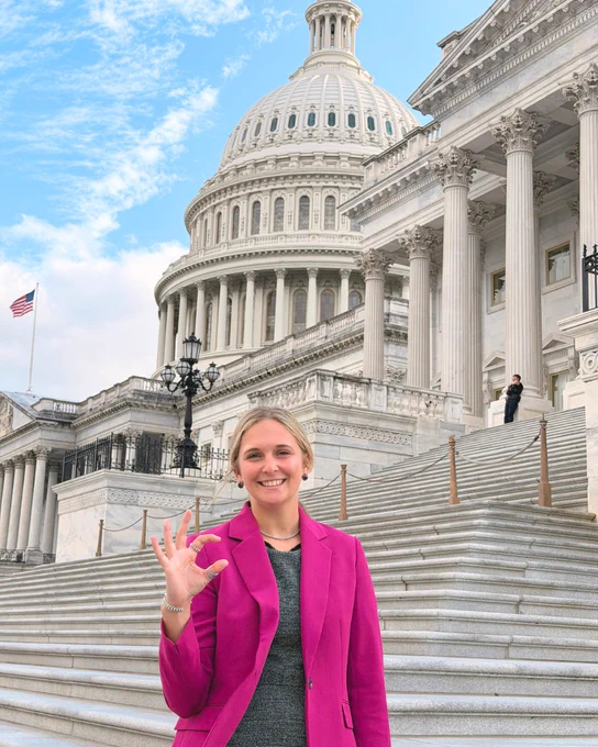 Erin Driscoll stands on Capitol Hill in Washington, D.C., making the K-State Wildcat hand signal.