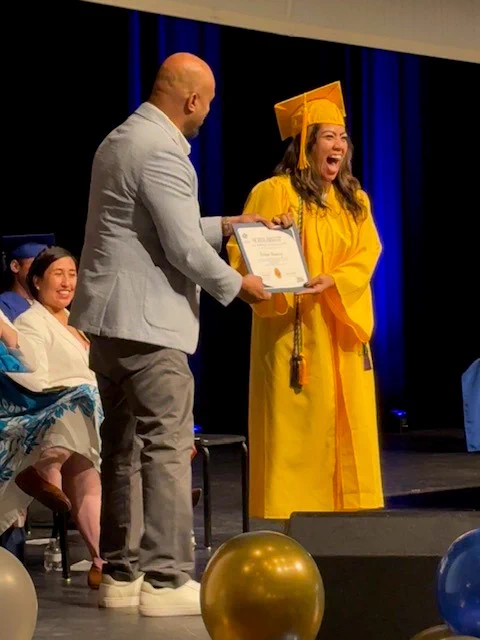 San Antonio Ready To Work graduate, Celena, accepting a scholarship..