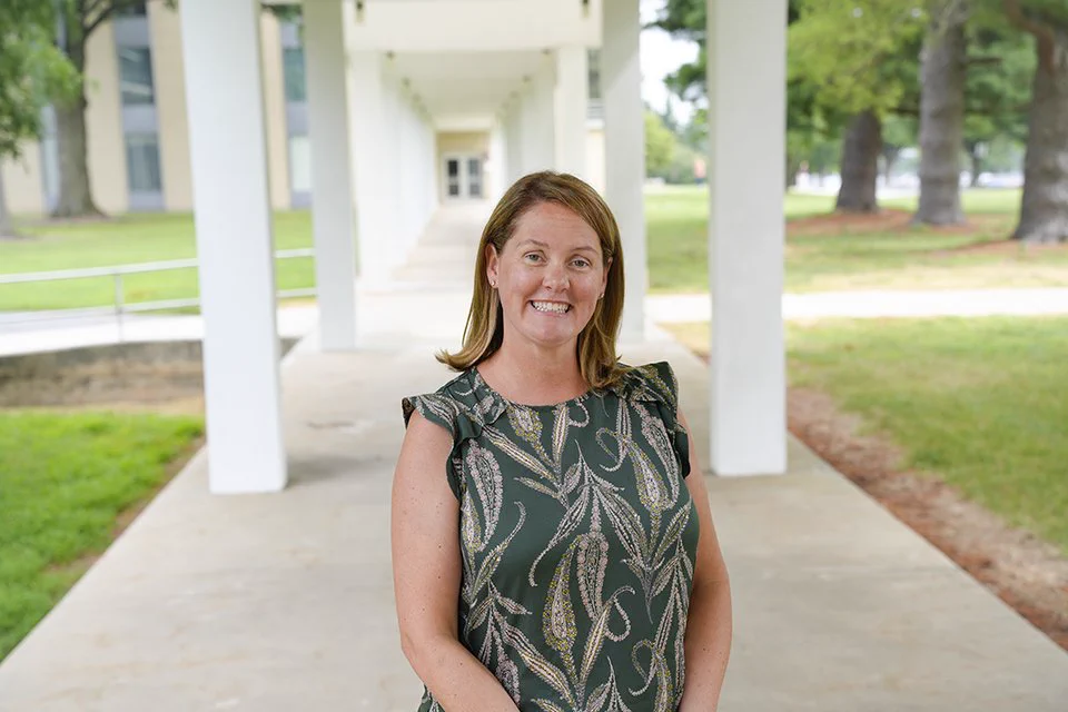 Erica Romsos poses outdoors on the NIST campus. 