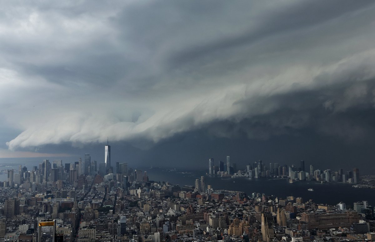 GaryHershorn's tweet photo. The quick progression of a thunderstorm moving across the Hudson River into lower Manhattan and One World Trade Center from NJ, seen from the Empire State Building in New York City, Friday evening #newyorkcity #nyc #newyork #thunderstorm https://t.co/0TcYcd7ZWk