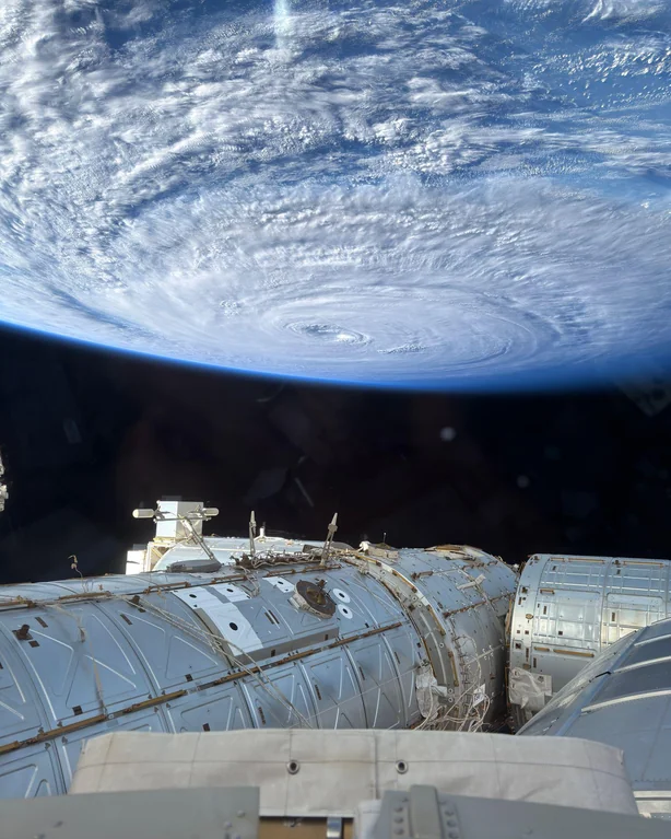 Rainmaker1973's tweet photo. The Pacific Ocean on August 2, 2026, as seen from the space station; photo taken from the dome with an iPhone. In the background, typhoon Dolphin.

[📸 Astronaut Anil Menon] https://t.co/O3efIFfmnC