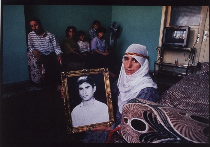 Robinthekurd's tweet photo. A Kurdish mother holding a photo of her son who was taken from her,  Northern Kurdistan by Ed Kashi. https://t.co/OYPZcshe5N