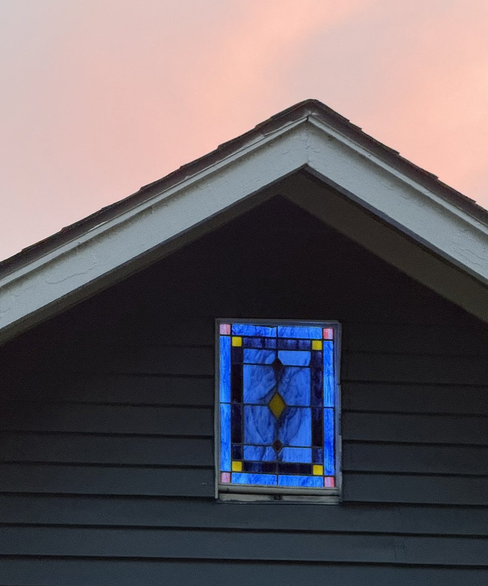 kunmuth's tweet photo. My favorite part of walking through my East Dallas neighborhood is appreciating whimsical details. I enjoy spotting the pops of character at peoples’ homes 🏡 . I’d never noticed this illuminated blue stained glass window before, but it really stood out at sunset 🌅 tonight. https://t.co/B9xBfcbw5K