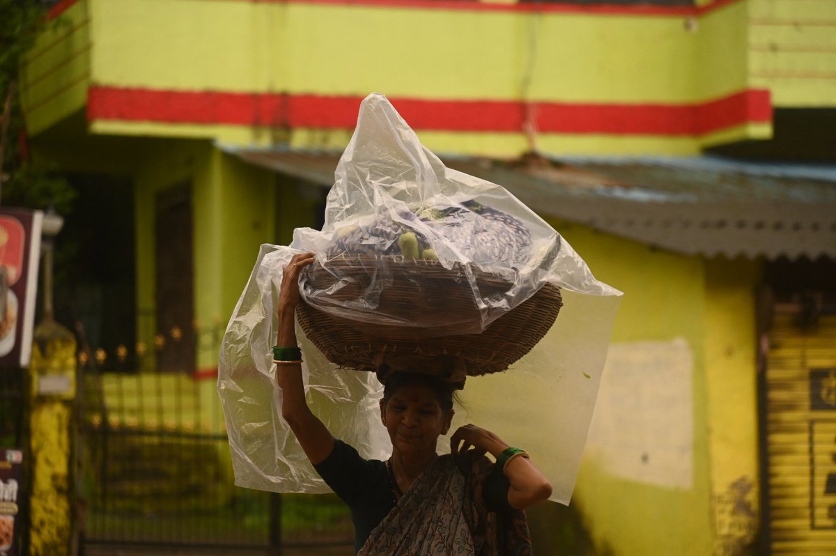 deep_nair16's tweet photo. A woman carries a basket of goods covered with a plastic sheet to protect it from heavy monsoon rainfall in Raigad, on the outskirts of Mumbai, Maharashtra, India, August 8, 2026.
#rain #monsoon #raigad #India https://t.co/EmOTEx0FaA