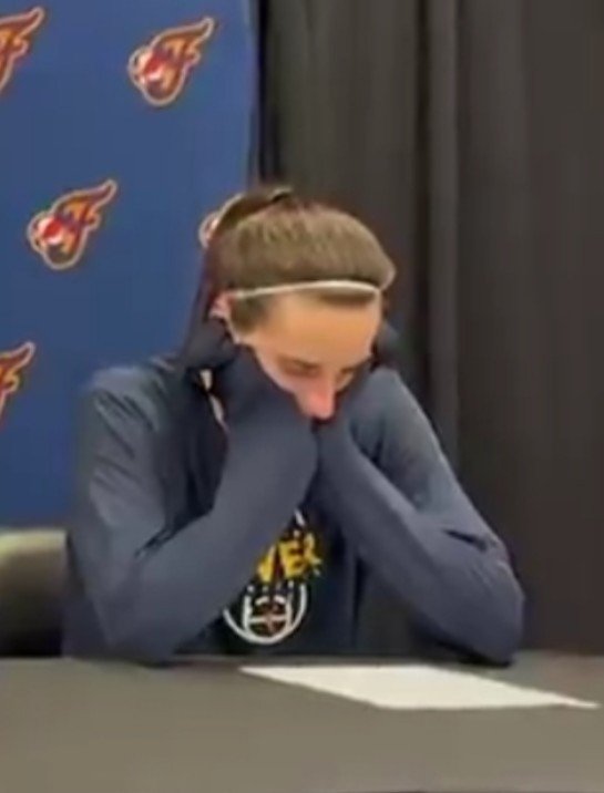 LangmanVince's tweet photo. The look you have at a press conference when you realize that your WOKE coach is defending the black racist who tried to purposely break your white friends neck during the basketball game you just played, but you don't have the courage to call her out! https://t.co/W4Jlk2gWhn