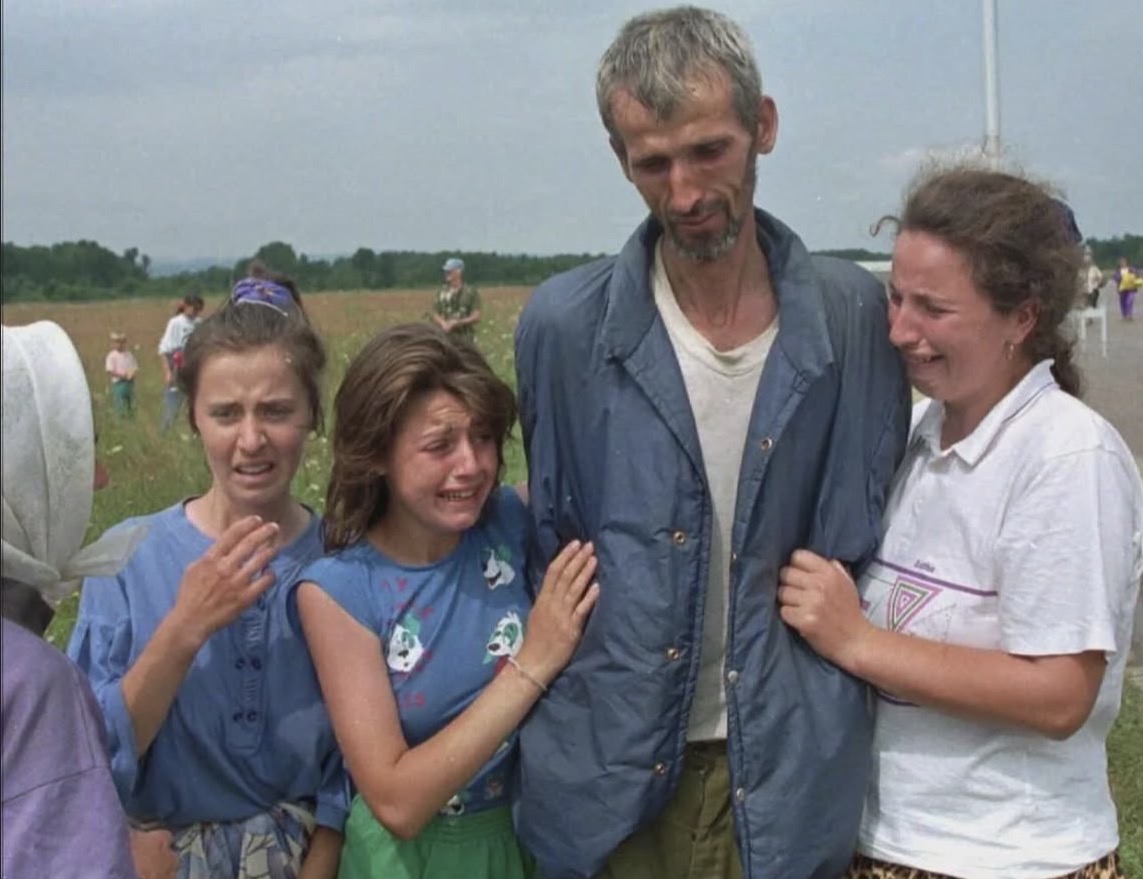 historigins's tweet photo. A family of Bosnian refugees cries as their father and husband arrives at the U.N. air base in Tuzla, Bosnia, after he survived the death march of six days from Srebrenica. https://t.co/NsI4Vlx1SE