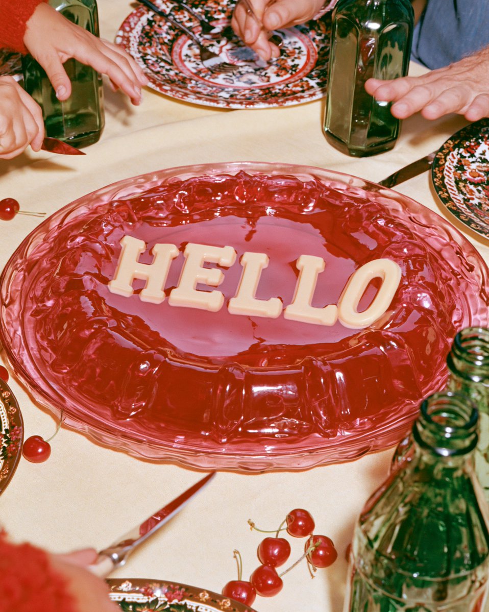 designer_hyosin's tweet photo. 1.

a candid retro diner booth scene photographed from across the table with hard direct flash, a tall glass ice cream sundae already partly eaten, melting vanilla cream, dark cherry syrup and whipped cream sliding down the inside of the glass, a flat chocolate wafer tucked into the top bearing the exact word "본인의 키워드" deeply embossed into the baked surface, two cropped hands visible holding spoons on opposite sides of the table, chrome napkin holder, red vinyl booth and green tabletop, vibrant 1980s diner colors, slightly faded film grain, casual awkward framing, fun old-movie atmosphere, not a centered dessert advertisement --profile m7441047528759361547 --quality 2 --ar 4:5 --style raw --s 27 --chaos 3 --hd

2.

a playful vintage dinner-table photograph captured at the exact moment a translucent ruby-red jelly wobbles after the table has been bumped, viewed from a low three-quarter angle, the exact word "본인의 키워드" suspended inside the jelly as opaque cream gelatin letters, slight natural distortion through the moving gelatin but still clearly readable, cropped hands and utensils frozen mid-motion around the dessert, patterned plates, green glass bottles, cream tablecloth and cherries scattered nearby, direct flash catching the glossy jelly surface, nostalgic 1980s editorial photography, rich saturated color with slight film fading, dynamic humorous composition, no sterile studio setup --profile m7441047528759361547 --quality 2 --ar 4:5 --style raw --s 27 --chaos 3 --hd