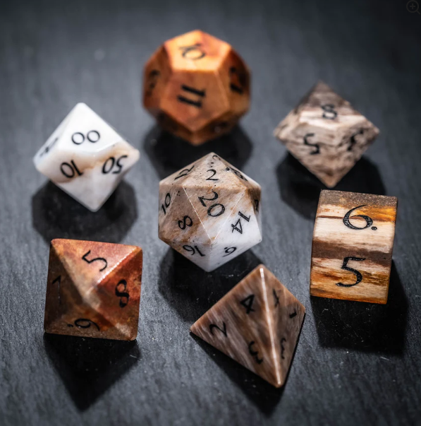 urwizards's tweet photo. These dice feel like they were carved from a forgotten age.
Petrified Wood dice with natural grain, earthy tones, and the kind of ancient magic druids probably refuse to explain.
Which set would your character carry?

#dnddice #ttrpgdice #gemstonedice #dicegoblin  #tabletoprpg https://t.co/ntogBbtH9Y
