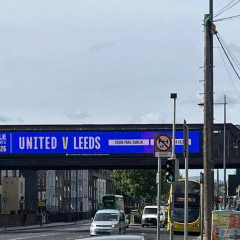 AwayDaysFB's tweet photo. Leeds fans are seething after Dublin billboards branded their pre-season clash “UNITED v LEEDS”.

The huge digital display simply reads “UNITED V LEEDS” — a decision many Leeds supporters have called “unacceptable.” Most Leeds fans also refer to their own club as “United” and feel the advert treats them as the secondary side.