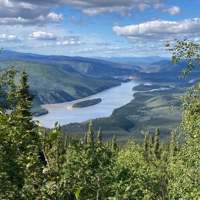 Sprawling landscape of rolling hills and a large river. 