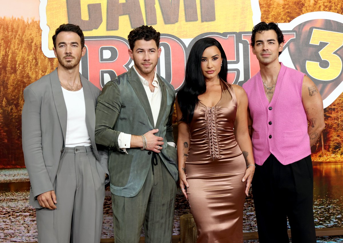 Variety's tweet photo. The Jonas Brothers and Demi Lovato pose together at the #CampRock3 world premiere. https://t.co/BJQc1pgBVg