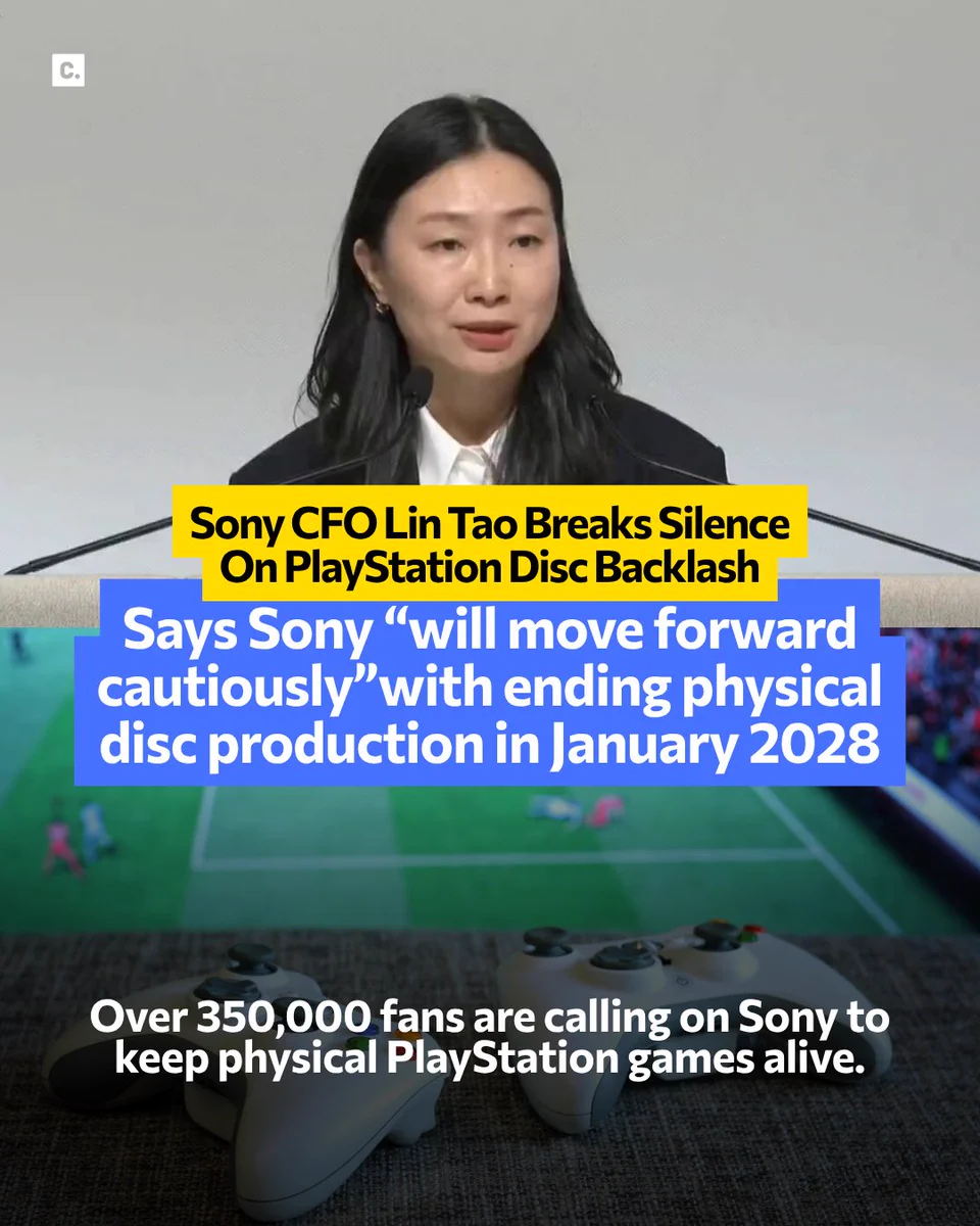 Woman at podium speaks about PlayStation disc production with controllers below.