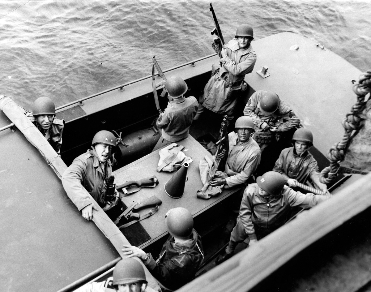 PattonOwn's tweet photo. On this day in 1942, while other generals watched from the safety of their ships, Patton climbed into a landing craft and went in with the first waves.

8 November 1942. Operation Torch. Off the coast of Morocco.

Major General George S. Patton sits low in the boat, helmet on, mouth open, already shouting orders. Right behind him is Master Sergeant George Meeks, his personal orderly and one of the few men he truly trusted.

This is not a staged moment. This is Patton on the morning he finally got to fight. He had waited years for this. Now the real war had started, and he refused to stay offshore. Within hours he would be on the beach at Fedala, directing traffic, cursing delays, and pushing his Western Task Force inland.

The general who would later drive the Third Army across France began exactly like this: wet, angry, and already too far forward!

Follow for more.