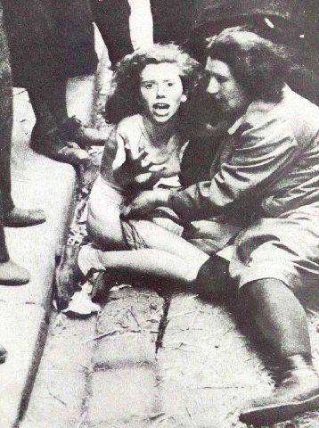 MarkoS2075's tweet photo. July 1, 1941: Lwów.

A single photograph captures the terrifying speed at which humanity can collapse. 

In the center, a young Jewish woman cries out in agony, beaten and stripped by a mob of her own neighbors, local militia, and occupying soldiers. 

She is completely defenseless against a sudden, violent eruption of hatred in the streets of her city.

Yet, beside her, an older woman reaches out. Amidst unimaginable chaos, she desperately tries to shield and cover the younger woman—a fragile, heartbreaking gesture of protection in a world entirely devoid of mercy.

We do not know the young woman's name or her ultimate fate, but we must never look away from her face. Her suffering is a permanent, painful warning of the catastrophic cost when empathy dies and neighbors become perpetrators.