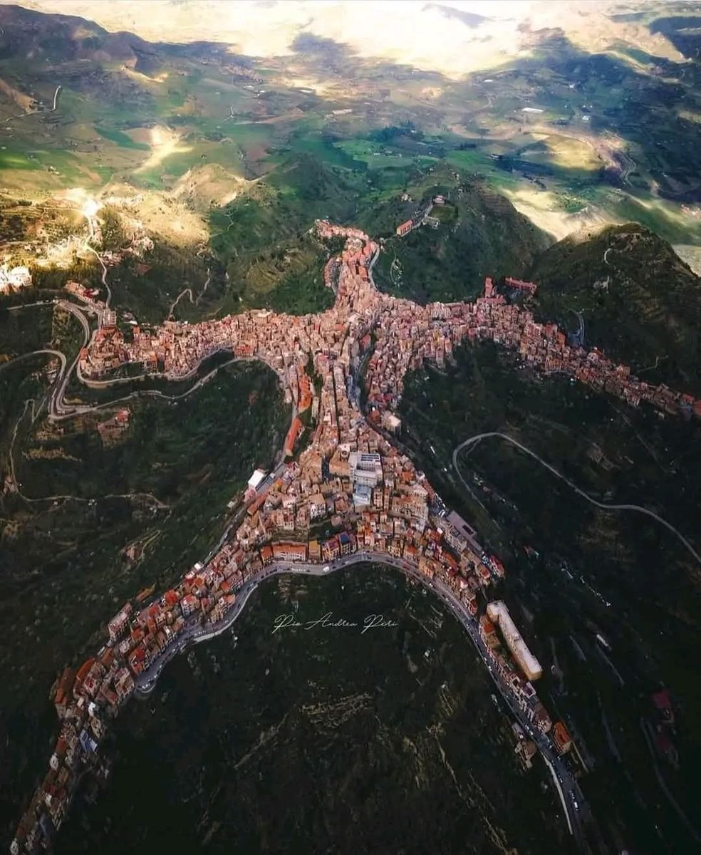 LeoDaVinciWave's tweet photo. From above, the Italian town of Centuripe looks almost unreal - shaped like a human figure with outstretched arms and legs. https://t.co/ZhFnuBuJmL