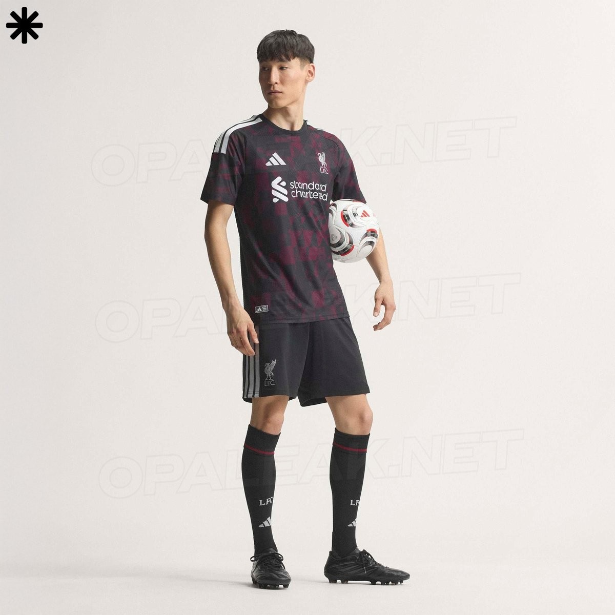 Footy_Headlines's tweet photo. 𝙇𝙞𝙫𝙚𝙧𝙥𝙤𝙤𝙡 𝟐𝟔-𝟐𝟕 𝙏𝙝𝙞𝙧𝙙 𝙆𝙞𝙩 𝙇𝙚𝙖𝙠𝙚𝙙 - 𝙊𝙛𝙛𝙞𝙘𝙞𝙖𝙡 𝙋𝙞𝙘𝙩𝙪𝙧𝙚𝙨

Official images of the Liverpool 26-27 third kit have been leaked by @opaleak, offering a complete look at Adidas' latest design for the club. The jersey features a black base paired with an abstract maroon graphic pattern across the front and sleeves, inspired by the waving flags seen on the Kop at Anfield.

All brand and sponsor detailing on the shirt is applied in monochrome silver, including the Adidas logo, the LFC Liver Bird crest, and the Standard Chartered chest sponsor. The shoulders carry Adidas' iconic Three Stripes in silver, while the back of the shirt is plain black. The 97 Hillsborough memorial emblem is positioned on the back collar.

Matching black shorts and socks complete the full kit ensemble, featuring silver Adidas stripes and LFC branding. The Liverpool 26-27 third strip is scheduled for an official launch on August 12, 2026.