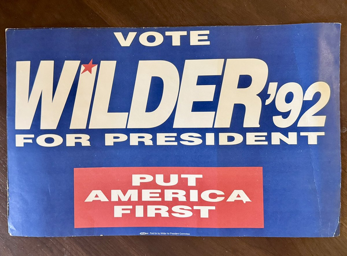 Blue 1992 Doug Wilder presidential campaign rally sign featuring large white “WILDER ’92 FOR PRESIDENT” lettering, a red star over the “I,” and a red box reading “PUT AMERICA FIRST.” Small print along the bottom reads “Paid for by Wilder for President Committee.”