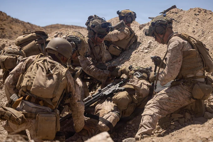 U.S. Marines and Sailors with Golf Company, 2nd Battalion, 2nd Marine Regiment, 2nd Marine Division, treat a simulated casualty during a defensive attack as part of the Mobile Assault Course in Training Area Prospect during Service Level Training Exercise 4-26 on Marine Corps Air Ground Combat Center, Twentynine Palms, California, Aug. 6, 2026. SLTE 4-26 is designed to be a challenging, realistic training environment that produces combat-ready forces capable of operating as an integrated Marine Air Ground Task Force across all domains of military operations. (U.S. Marine Corps photo by Sgt. Alexis French)\n\n