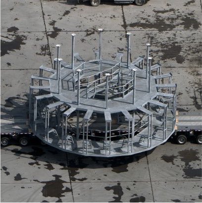 muskonomy's tweet photo. NEWS: SpaceX may be building toward faster Starship launches, based on a new structure spotted at Starbase.

After every launch, crews install scaffolding at the pad to service the clamps that hold the rocket down.

Now a new structure has arrived by barge, spotted by Starbase photographer RGV Aerial Photography.

SpaceX watcher ChromeKiwi thinks it is a permanent service platform for those clamps, which would speed up the work between launches.

His read is that it is only for servicing the mount, not for stacking the rocket, since it hangs inside the launch mount.

One note: this is an educated guess from a fan, not something SpaceX has confirmed.

Source: ChromeKiwi on X, August 2026
Photo from: @RGVaerialphotos