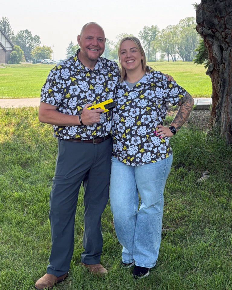MTCorrections's tweet photo. Twinning for Taser training! #MTCorrections Master Taser Instructors and P&amp;P Officers Cory Purves and Bre Lewis brightened up the P&amp;P Academy’s Taser training with matching Hawaiian shirts. If you look closely, you can see tiny Tasers and lightning bolts within the floral design. https://t.co/zXbhDAskXo