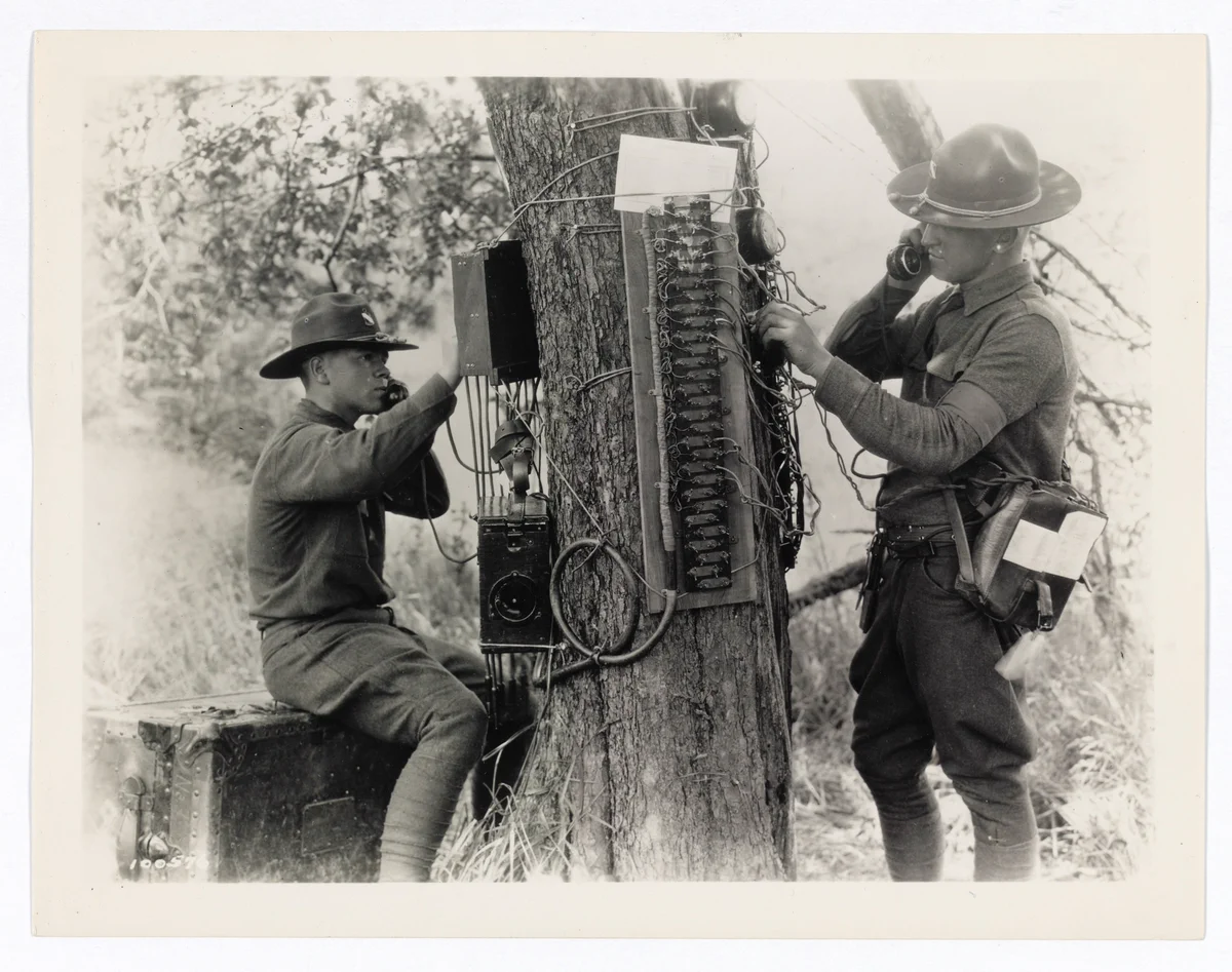 Field telephone and switchboard operators in action during maneuvers. NAID: 329585448
