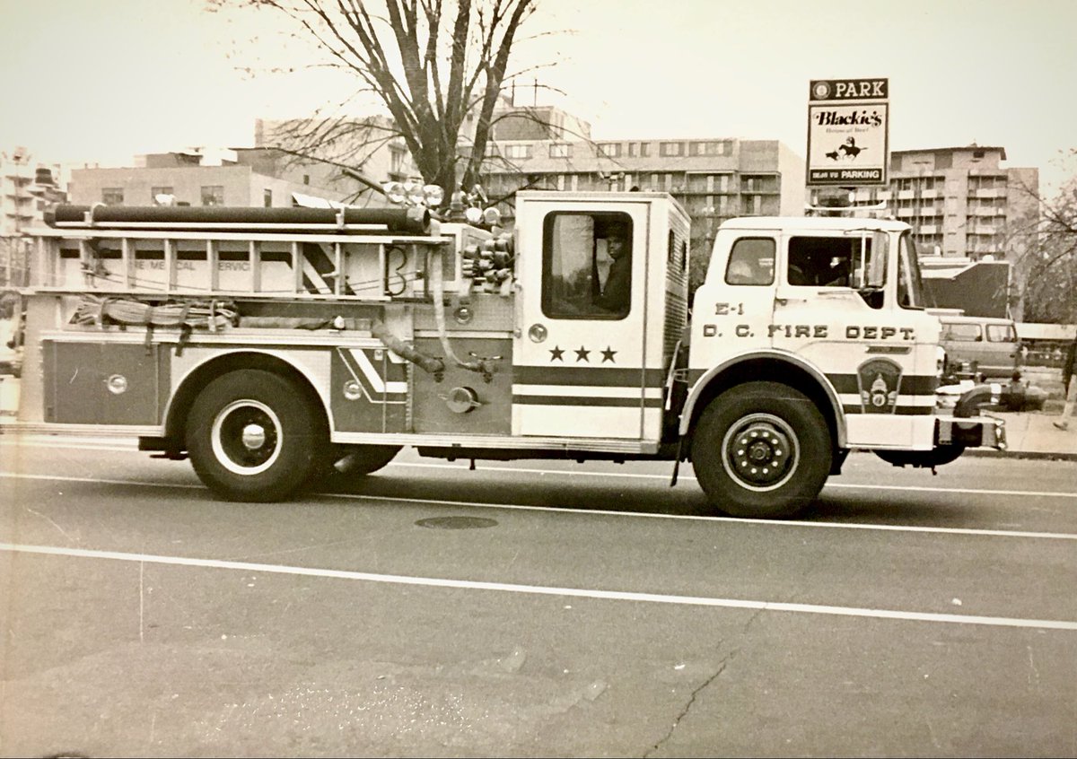 DCFDKelleher's tweet photo. A changing DC landscape. I took this photo in the early 1990s as @dcfireems Engine 1 responded from their firehouse and westbound on M St. NW. Behind it: The lot for Blackie’s House of Beef & Lulu’s. Today, the site is home to the Ritz-Carlton and retail. #Ward2DC #DC #Fire #EMS https://t.co/diNUEnlJI3