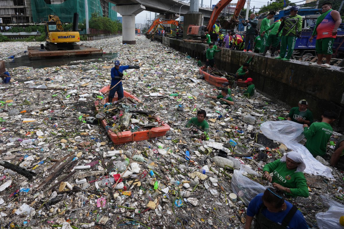 lajornadaonline's tweet photo. Las intensas lluvias del monzón arrastraron una gran cantidad de basura y escombros al canal de agua Redemptorist, en Parañaque, Metro Manila, Filipinas.

Un trabajador utilizó flotadores improvisados para realizar las labores de limpieza.

📷 Fotos: Ap https://t.co/1GxKuVxIO1