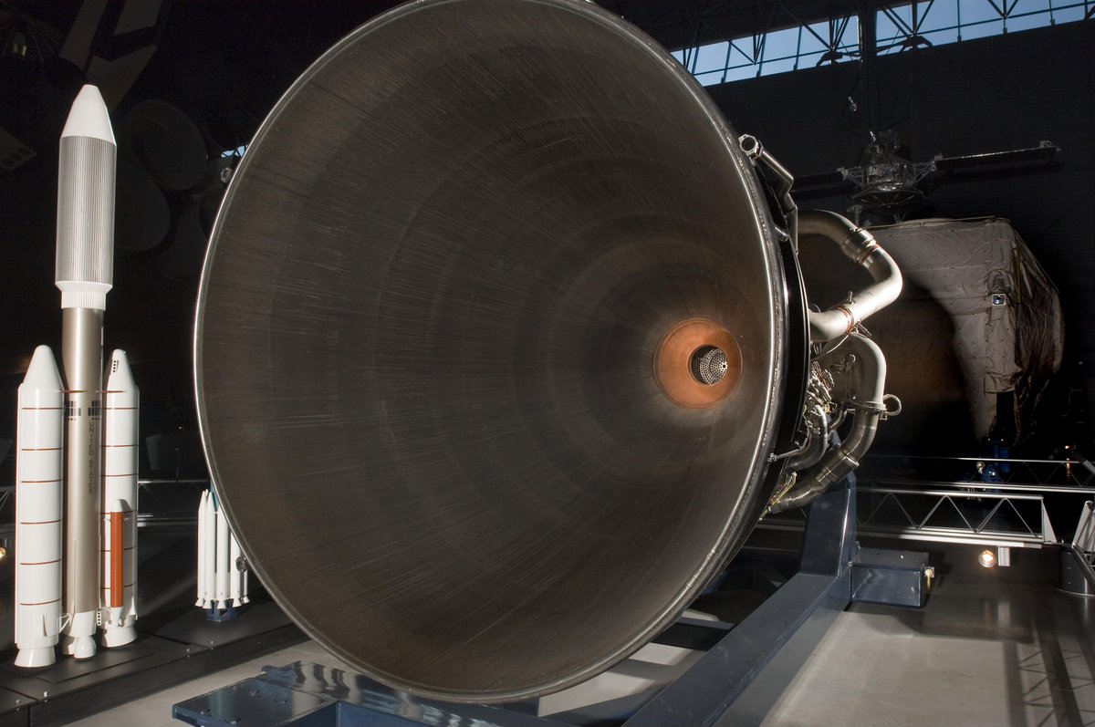 Arkasiraee's tweet photo. A liquid rocket engine has a problem that seems almost impossible to solve, its combustion chamber can contain gases approaching 3,000-3,300°C, while the metal containing them would rapidly lose its strength at those temperatures. 

The solution is remarkably simple in principle and extraordinarily difficult in execution. The cryogenic propellant itself becomes the coolant to remove the heat from the metal. 

In an engine such as SpaceX's Raptor for example, cryogenic liquid methane, whose normal boiling point is about -162°C, is forced through precisely engineered passages built into the chamber and nozzle walls before reaching the combustion system. 

The fuel absorbs heat from the metal while flowing through a microscopic heat exchanger that is effectively manufactured into the engine itself. Near the throat, heat flux can exceed 10 MW/m², making this one of the most demanding thermal environments in propulsion.

The complexity is in controlling thousands of tiny flow paths simultaneously. Their size, spacing, wall thickness, surface finish and flow resistance determine how evenly heat is removed. 

Too little cooling in one region creates a local hot spot, a restriction, void or dimensional defect can reduce coolant flow precisely where the heat load is highest. 

The sequence can become catastrophic, reduced cooling leads to rising wall temperature which then causes material weakening and deformation, which then creates further disruption of the cooling flow and  burn-through where the nozzle fails.  

That makes the materials and manufacturing process inseparable from the thermal design. 

Highly conductive copper alloys such as GRCop-42 have been developed for high-heat-flux chambers, while modern additive manufacturing can create intricate internal cooling geometries that are extremely difficult to reproduce conventionally. 

Meanwhile, large engines move extraordinary quantities of propellant, Vulcain engine, for example, processes roughly 235 kg of propellant every second, including about 41 kg/s of hydrogen through its engine system.

The real manufacturing constraint is therefore not simply making a rocket engine withstand extreme combustion temperatures and pressures. 

It is manufacturing a pressure vessel whose walls efficiently contain a precision heat exchanger, distributing enormous propellant flow exactly where the heat is trying hardest to destroy it and doing so reliably every time the engine fires under immense pressures.