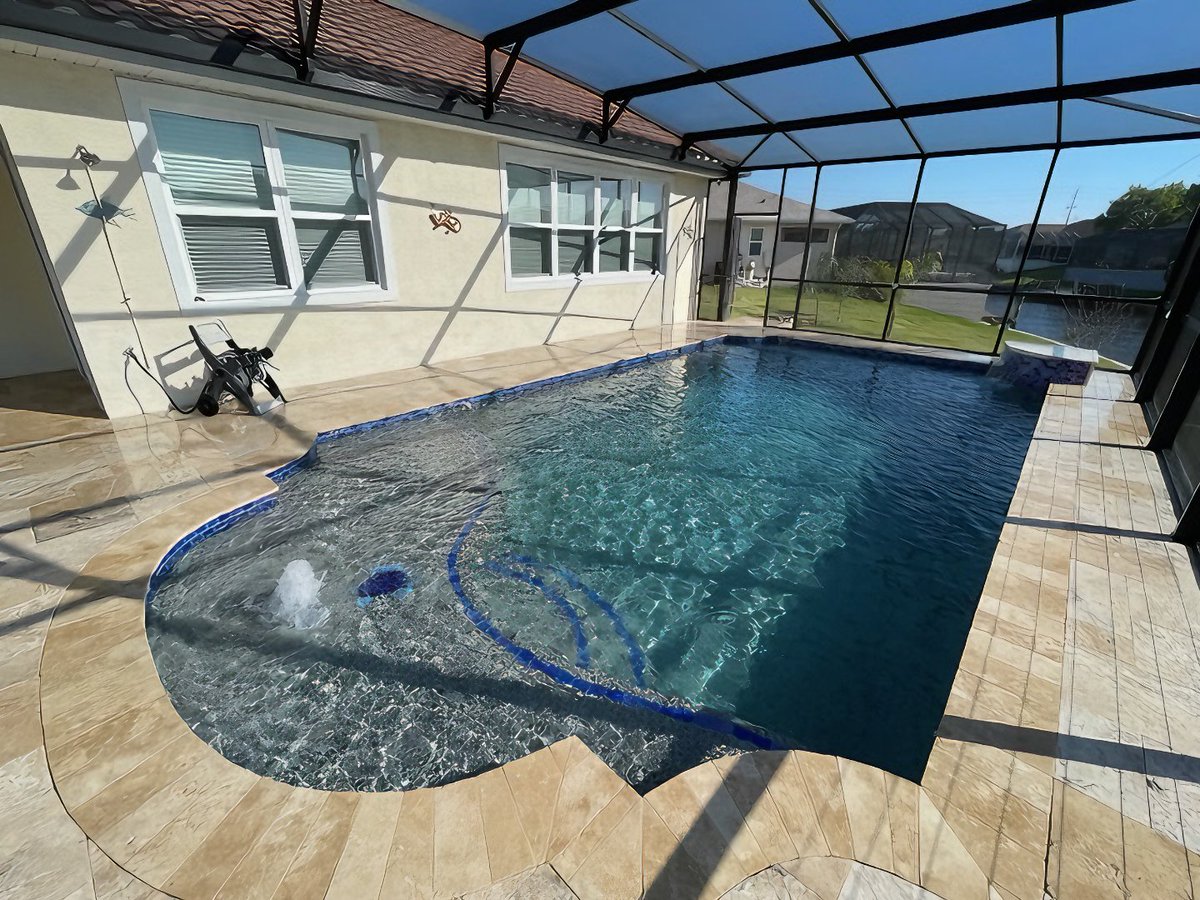 aguaconstruct's tweet photo. A sun shelf is more than a good-looking pool feature. It’s one of the most useful spaces in the entire design. 

Perfect for lounging in shallow water, cooling off without fully swimming, giving kids a comfortable play area, or simply pulling up a chair &amp; enjoying the sunshine. https://t.co/iQ8NP8DZ5s