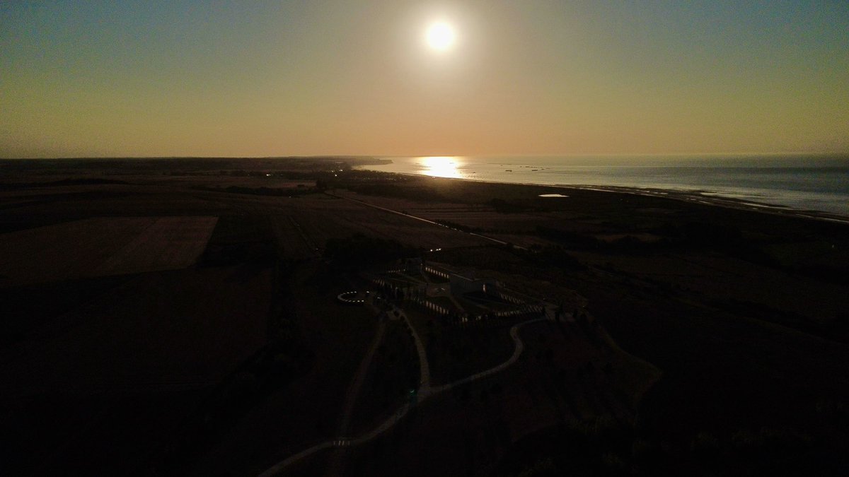 britishmemorial's tweet photo. The solar eclipse at the Memorial, overlooking Gold Beach. ☀️🌙 https://t.co/QeZGBZNtJL