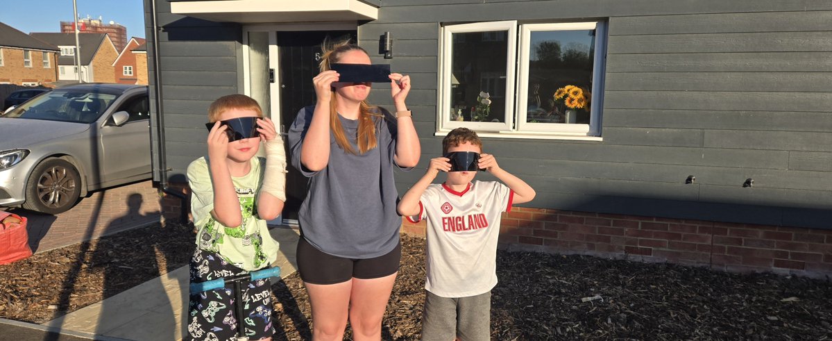 Jrbty93's tweet photo. #OctoEclipse @OctopusEnergy  Couldn't get hold of Eclipse glasses! but remembered the blackout film we used on the kids bedroom windows allows us to look at the sun! So here they all are! 
Excuse my eldest with his trampoline incident broken arm! https://t.co/wWPC78vkAX