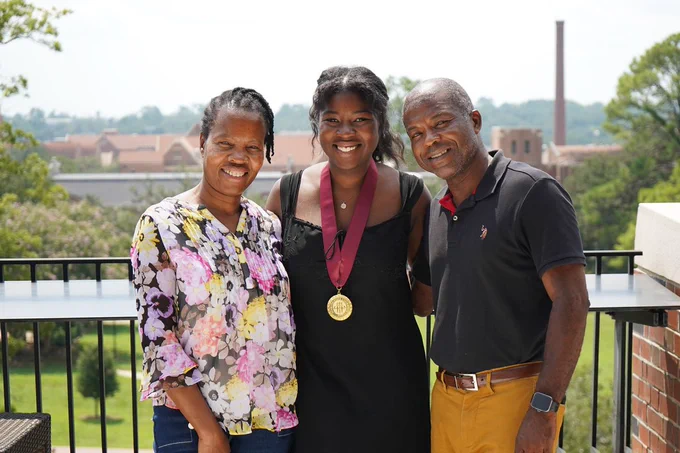 A summer 2026 honors graduate poses with family at the Honors Medallion Celebration on July 30, 2026.