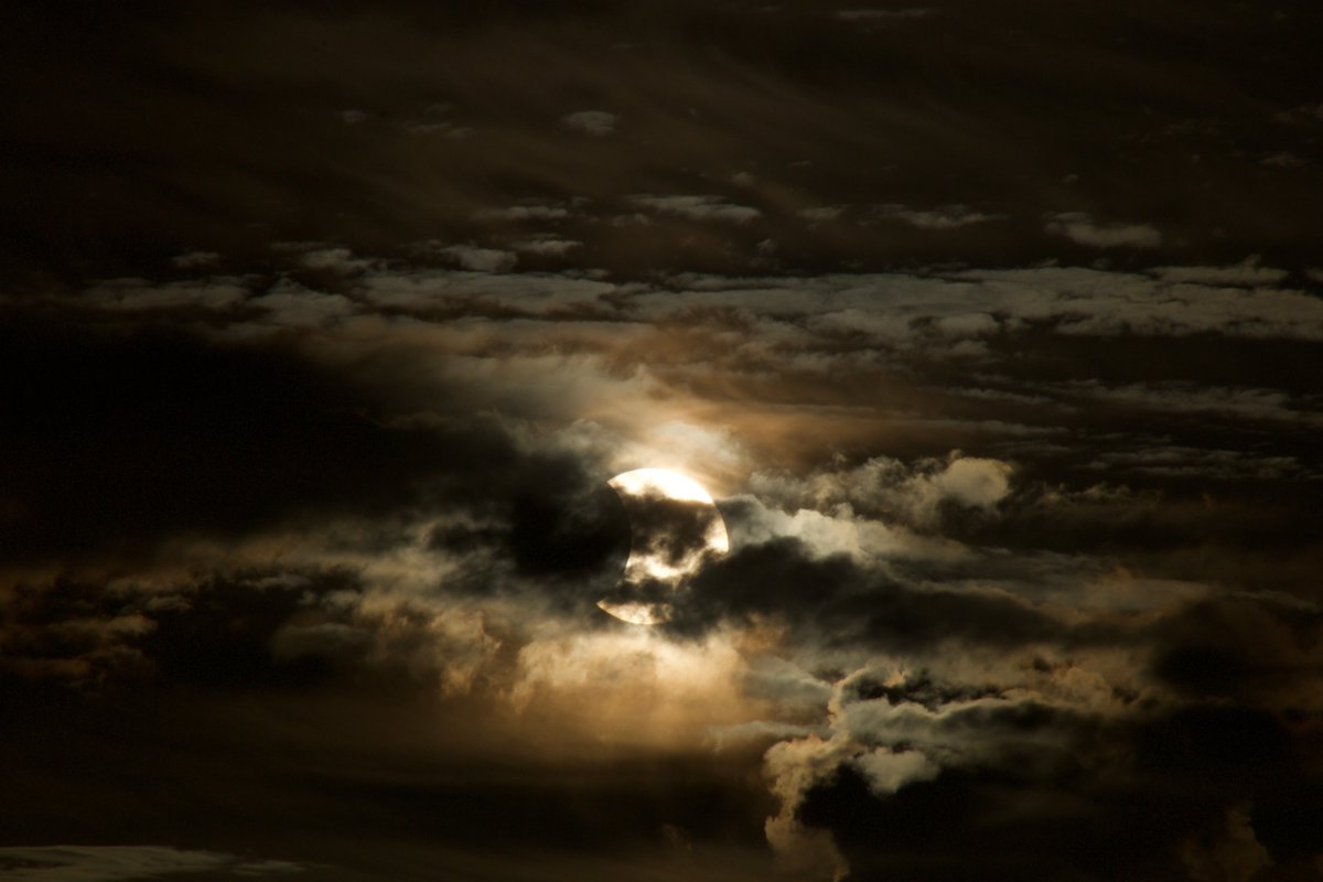 Kristin_Mae's tweet photo. Really loving all these solar eclipse shots on the timeline. I thought I'd share one from Hawaii years ago of a partial eclipse. It was mostly ruined by cloud cover, but it was still amazing nonetheless. https://t.co/UOdB3MX9Gk