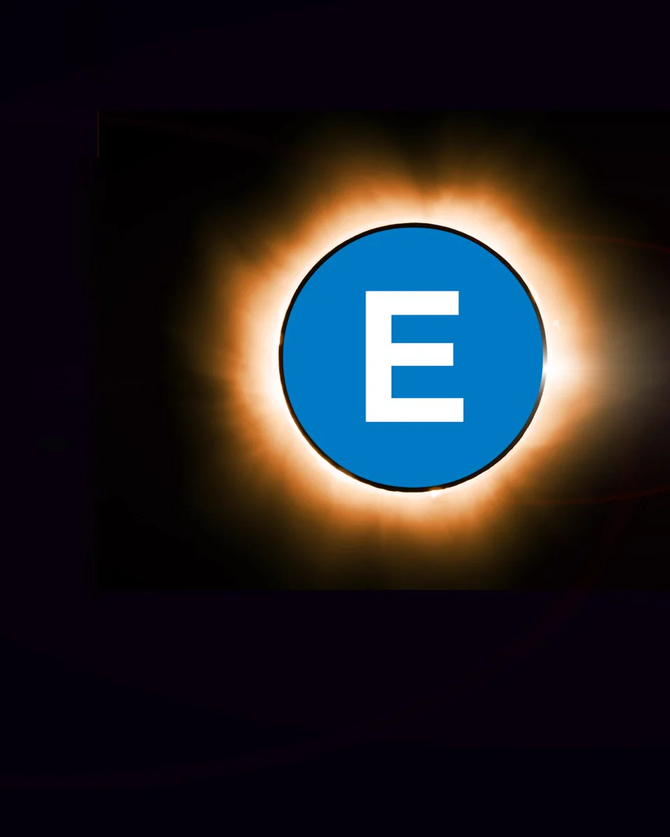Photo of an E subway bullet in front of a solar eclipse