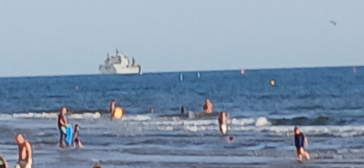 RowanAmberMill's tweet photo. The partial eclipse at Exmouth Beach, Devon. I saw it but I couldn't capture it try as I might. The lifeboat launched. Oh, and there is a warship just off the coast. #partialeclipse #photographyfailure #warship https://t.co/Cm9ThI8DRw